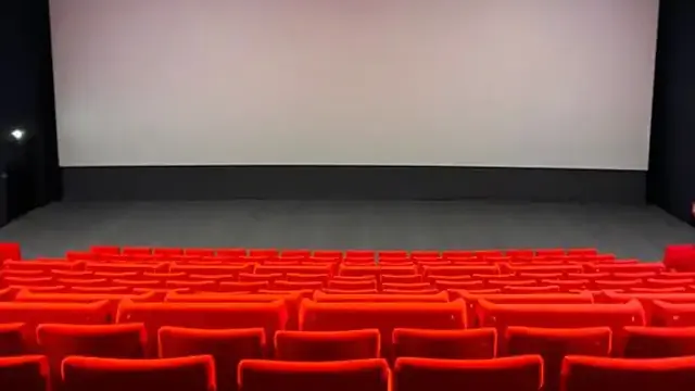 Empty red seats in a movie theater