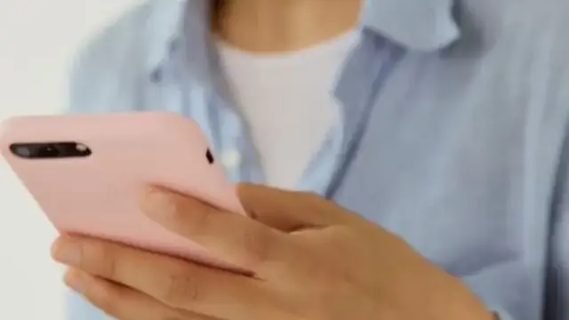Woman relaxing with a smartphone on a couch